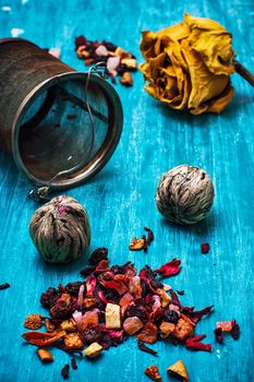 dried fragrant tea leaves on wooden turquoise background.Shallow DOF