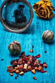 dried fragrant tea leaves on wooden turquoise background.Shallow DOF