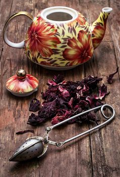 the teapot in the background of elite sorts of tea.the image is tinted in vintage style