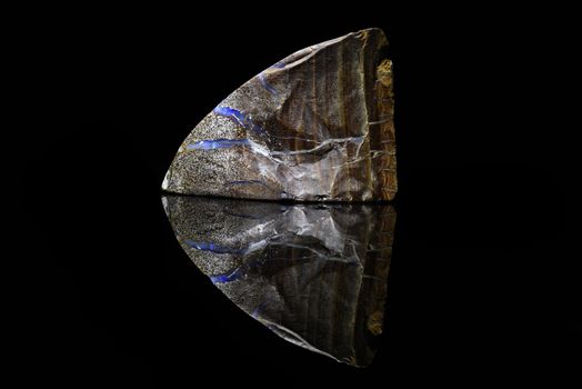 Sample of a beautiful natural Boulder Opal specimen isolated on black background
