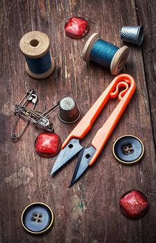 tools seamstresses on wooden background.the image is tinted in vintage style