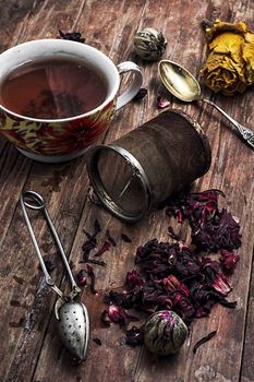 tea strainer and different varieties of tea leaves on wooden background.The toned image