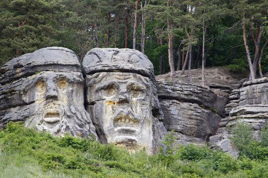 Heads of Devils are about 9 m high rock sculptures of giant heads carved into the sandstone cliffs in the pine forest above the village Zelizy in the district Melnik, Czech republic. It is the work of sculptor Vaclav Levy, who created in the period 1841-1846.