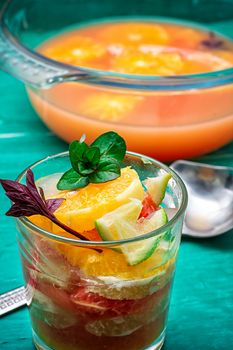 fresh juice from oranges,kiwi and grapefruit on turquoise wooden background.Selective focus