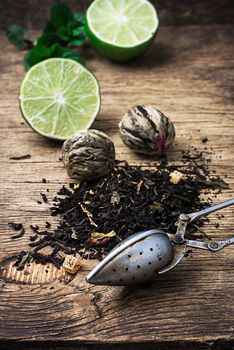 tea brew with lime and mint on wooden background in rustic style.Selective focus