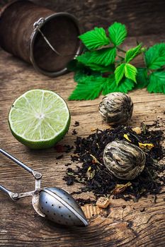 tea brew with lime and mint on wooden background in rustic  style