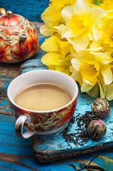 Cup of tea and a bunch of fresh daffodils