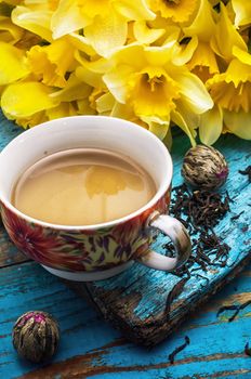 Cup of tea and a bunch of fresh daffodils