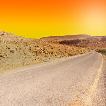 Meandering Road in Sand Hills of Judean Mountains at Sunset