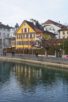 Houses on the Embankment in the Old City of Thun in Switzerland. Thun is a city in Swiss canton of Bern. It is located where Aare river flows out of Lake Thun.