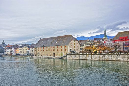 Waterfront and Clock Tower with Landhaus in Solothurn. Solothurn is the capital of Solothurn canton in Switzerland. It is located on the banks of Aare and on the foot of Weissenstein Jura mountains