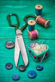 thread buttons for crafts on turquoise wooden background.Selective focus