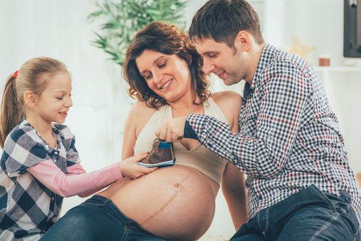 Portrait of a beautiful young family expecting a new baby. 