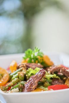 Warm salad with veal closeup