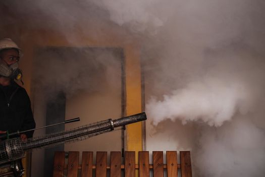 VENEZUELA, Caracas: A member of a fumigation crew works to exterminate Aedes mosquitoes carrying the rapidly spreading Zika virus in the slums of Caracas, Venezuela on February 3, 2016. As of February 4, there have been reports of at least 255 cases of the rare Guillain-Barre syndrome  which causes the immune system to attack the nerves  potentially linked to the Zika virus in Venezuela.