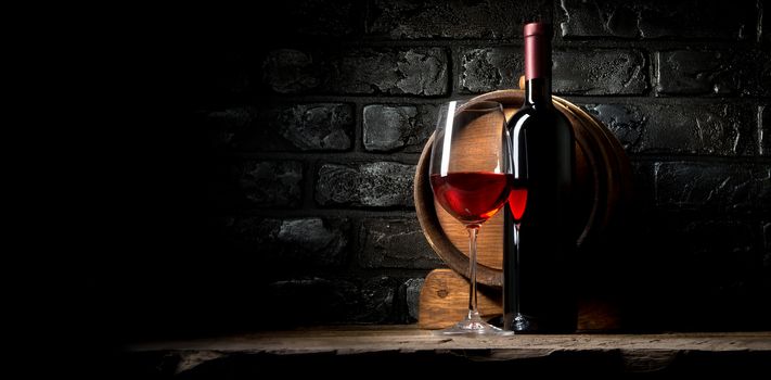 Red wine on a background of old black bricks