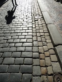 Paved Road With A Human Shadow in Prague, Czech Republic