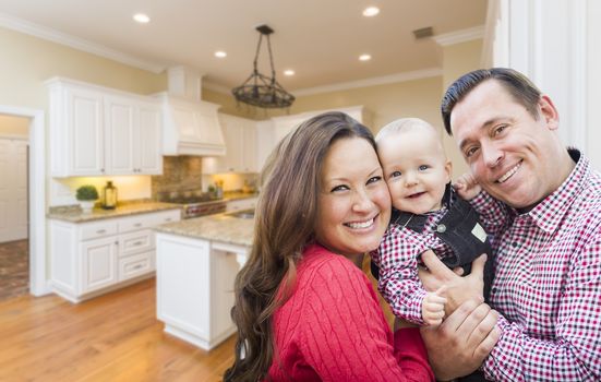 Young Happy Family Inside Beautiful Custom Kitchen.