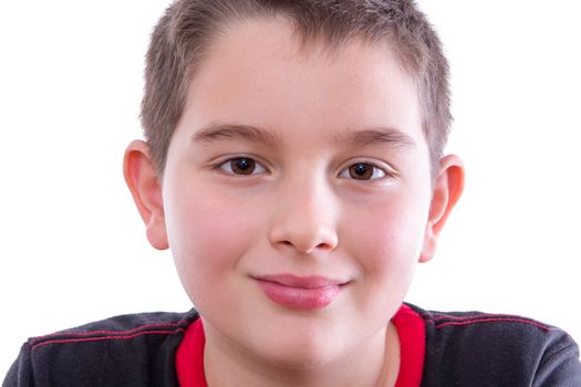 Head and Shoulders Close Up Portrait of Young Boy Wearing Black and Red T-Shirt and Staring Contentedly at Camera with Shy Smily in Studio with White Background and Copy Space
