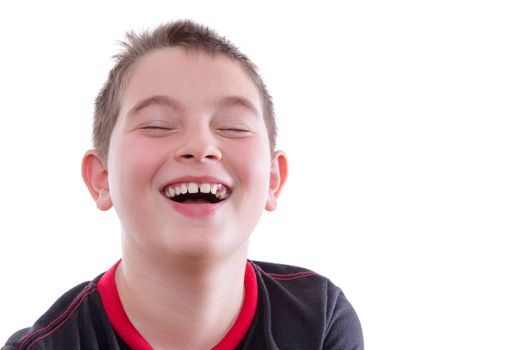 Head and Shoulders Close Up Portrait of Joyful Young Boy Wearing Red and Black T-Shirt and Laughing with Eyes Closed in Studio with White Background and Copy Space