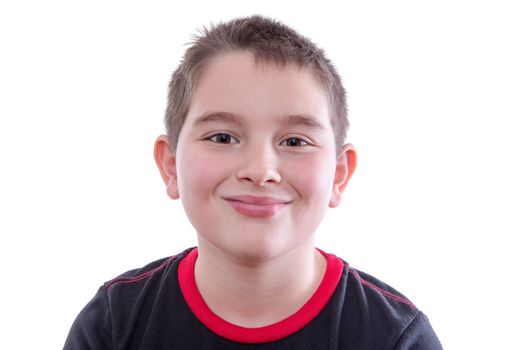 Head and Shoulders Close Up Portrait of Young Boy Wearing Red and Black T-Shirt and Smiling at Camera in Studio with White Background and Copy Space