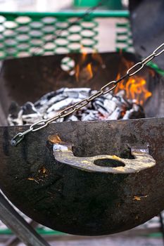 improvised brazier with burning wood in it.Selective focus