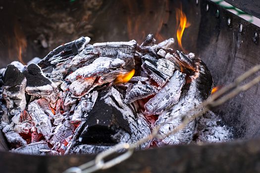 improvised brazier with burning wood in it.Selective focus