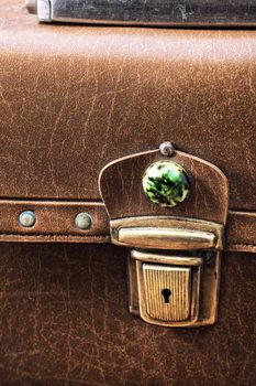 old-fashioned suitcase in yellow leather with metal latch