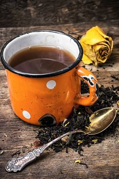 enamel cup with herbal tea amid scattered on the welding table.Selective focus