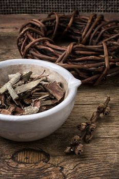 medicinal licorice rolled in  coil and aspen bark on wooden background.Selective focus