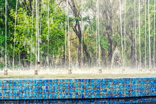 old street fountain on the background of splashing water.Selective focus