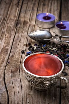 still life with old cups of brewed herbal tea and scattered welding