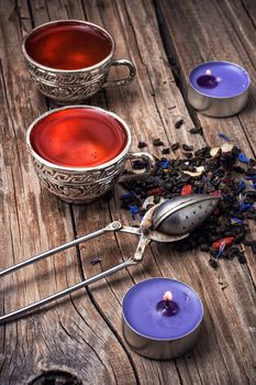 still life with old cups of brewed herbal tea and scattered welding