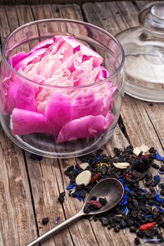 scattered welding of unusual herbal tea amid peony bud.Selective focus.Photo tinted