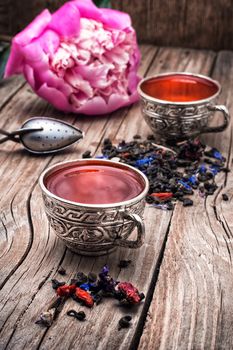 still life with old cups of brewed herbal tea and scattered welding