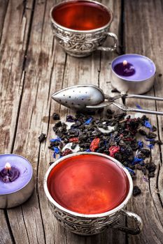 still life with old cups of brewed herbal tea and scattered welding.Photo tinted