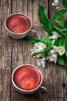 still life with old cups of brewed herbal tea and scattered welding