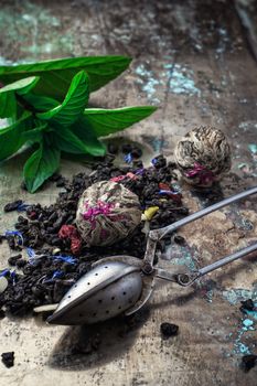 two iron bowls with herbal tea on background of mint leaves.Selective focus