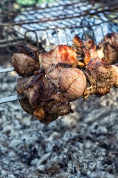 grilling pork on skewers over charcoal in the grill.Selective focus