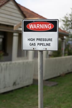 A sign warning that there is a high pressure gas main underground.