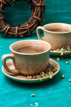 fragrant tea brewed with chamomile in ceramic mugs