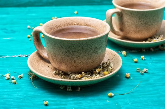 two ceramic cups of tea brewed from dried chamomile.Selective focus