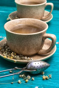 two ceramic cups of tea brewed from dried chamomile