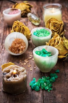 sea salt for Spa treatments with ceramic cups on the background of the buds dried yellow roses