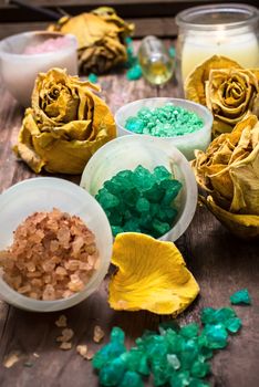 sea salt for Spa treatments with ceramic cups on the background of the buds dried yellow roses
