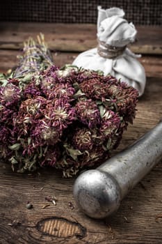 iron mortar and whisk in the background healing,harvested medicinal herbs for the winter