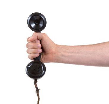 Male hand holding retro landline telephone, nearly broken cable