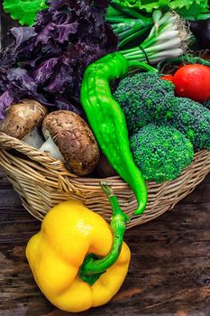 mushrooms and broccoli,leeks,lettuce, peppers in basket in rustic style.