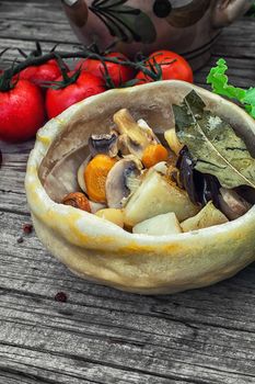 vegetable hot plate made of baked dough on wooden countertop.Photo tinted