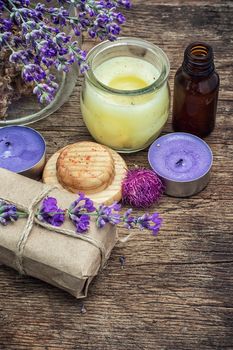 candles,flowers lavender oil for spa treatments on wooden background.Photo tinted.Selective focus